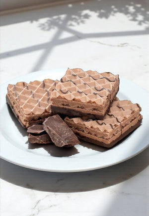 Delicious chocolate wafer cookies on a white plate, showcasing a tempting dessert perfect for sweet cravings.
